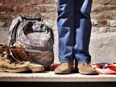 man with backpack by feet